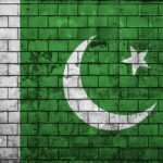 Pakistan flag is painted onto an old brick wall